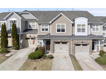 Charming townhouse with attached garages, neutral siding, and manicured landscaping at 2821 Casona Way, Raleigh, NC 27616