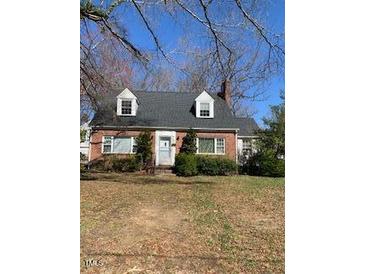 Charming brick home featuring a well-maintained front yard and classic architectural details at 333 Leasburg Rd, Roxboro, NC 27573
