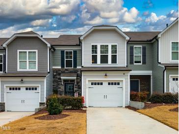 Charming townhome featuring a one-car garage and manicured landscaping at 372 White Oak Ridge Dr, Garner, NC 27529