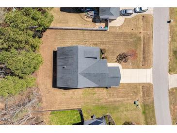 Aerial view of a home with a driveway and lawn, showing the roof and surrounding landscape at 96 Foxtail Ct, Clayton, NC 27520