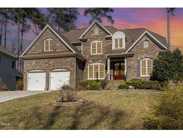 Beautiful two-story brick and stone home with a two-car garage and manicured lawn at 10016 Porto Fino Ave, Wake Forest, NC 27587