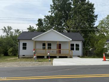 Charming single-story home featuring a new front porch and a freshly paved driveway at 1012 W Webb Ave, Burlington, NC 27217