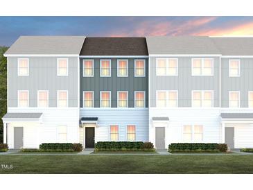 Charming new construction townhomes feature modern design, green landscaping, and welcoming front entrances at 1485 Hasse Ave, Apex, NC 27502