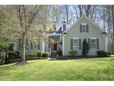 Charming home with a well-manicured lawn, complemented by decorative shutters and tasteful landscaping at 1705 Mcrae Pl, Hillsborough, NC 27278