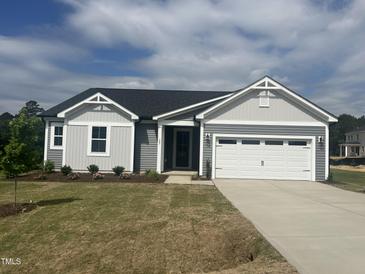Charming single-story home with a well-manicured lawn and a two-car garage in a Gathering-friendly neighborhood at 207 Golfview Ave, Benson, NC 27504