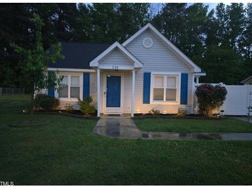 Charming single-story home with blue shutters and a well-manicured front yard with garden beds and walkway at 225 Sebastian Way, Rocky Mount, NC 27804