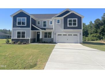 Two-story home with a gray and navy exterior, two-car garage, and a well-manicured front lawn at 245 Golfview Ave, Benson, NC 27504