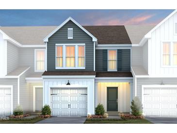 Charming two-story townhome with a two-car garage and inviting front porch, perfect for a starter home at 4004 Kidd Pl, Durham, NC 27703