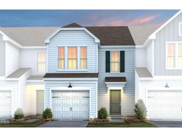 Charming two-story home with a garage and beautifully landscaped front yard at 4006 Kidd Pl, Durham, NC 27703