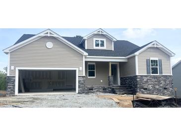 Charming, single-Gathering home with a two-car garage, craftsman details, and stone accents in a construction zone at 47 Tee Time Ter, Benson, NC 27504