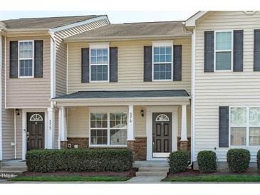 Charming two-story home with stone accents, gray shutters and landscaped yard at 5210 Blue Lagoon Ln, Raleigh, NC 27610