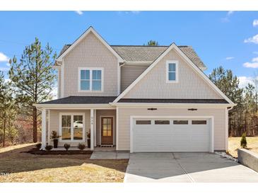 Charming two-story home featuring a 2-car garage, landscaped yard, and craftsman details at 934 Woodland Rd, Creedmoor, NC 27522