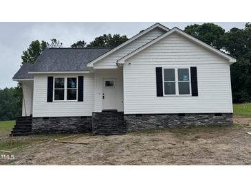 Charming single-story home featuring white siding, black shutters, and a stone foundation at 9600 Stallings Rd, Spring Hope, NC 27882