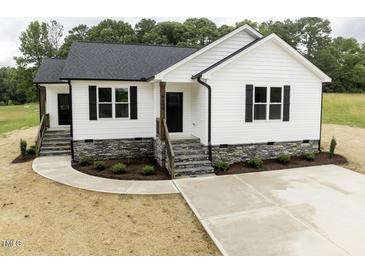 Charming new construction home with white siding, black shutters, and stone foundation accents at 9600 Stallings Rd, Spring Hope, NC 27882