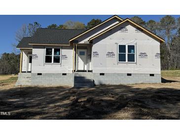 New construction home exterior featuring a white front door, grey shingles, and block foundation at 9600 Stallings Rd, Spring Hope, NC 27882