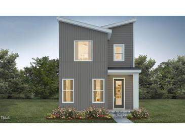 Modern two-story home with gray siding, white-framed windows, and a beautifully landscaped front yard at 101 Parkland Dr, Pittsboro, NC 27312