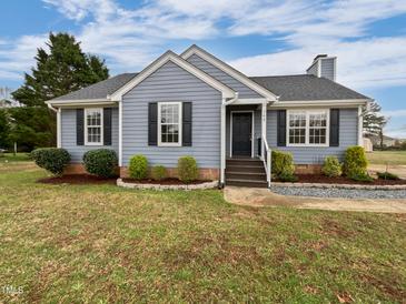 Charming home featuring a landscaped yard, gray siding, black shutters, and a welcoming entrance at 108 New Castle Ct, Youngsville, NC 27596
