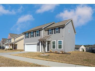 Two-story home with gray siding, black shutters, and a well-manicured front yard at 140 Ashberry Ln, Franklinton, NC 27525