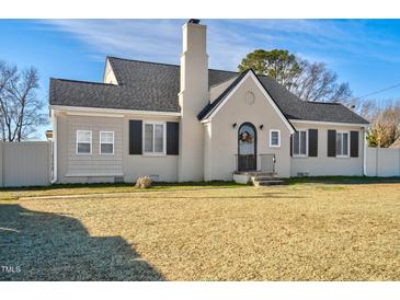 Charming home featuring a chimney, gray roof, and well-kept lawn, blending classic and modern appeal at 2120 Cokey Rd, Rocky Mount, NC 27801