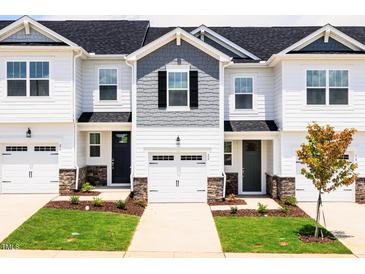 New townhomes with light siding, well maintained lawn and landscaping at 22 Twin Birch Dr, Angier, NC 27501