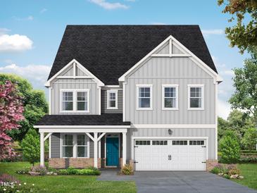 Two-story home with light gray siding, a front-facing garage, a blue front door, and professionally landscaped front yard at 4825 Bristol Meadow Dr, Raleigh, NC 27603