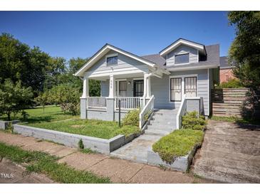 Charming gray two-story home featuring a welcoming front porch and landscaped front yard at 508 S Swain St, Raleigh, NC 27601