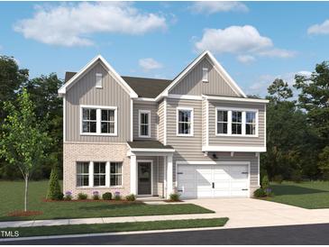 Two-story home with gray siding, brick accents, attached two-car garage and well-manicured lawn at 556 Contempo Dr # 22, Rolesville, NC 27571