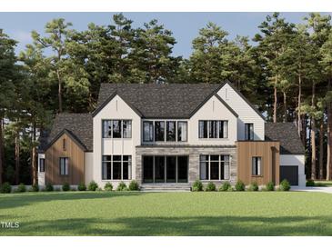 Stunning exterior elevation view of modern home with stone accents, large windows, and professionally landscaped yard at 5808 Norwood Ridge Dr, Raleigh, NC 27614