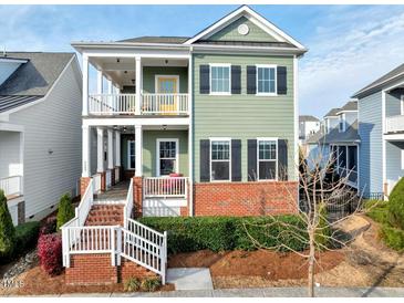 Charming two-story home with a brick foundation and welcoming double porches at 6609 Truxton Ln, Raleigh, NC 27616