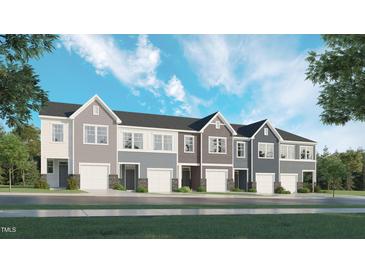 Charming townhome exteriors featuring attached garages, varied siding and classic architectural details at 868 Pilot St # 2, Haw River, NC 27258