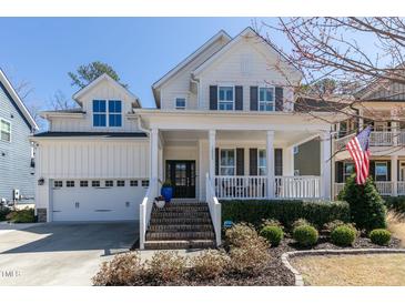 Charming two-story home featuring a welcoming front porch, well-manicured landscaping, and a classic architectural style at 1025 Chelsea Run Ln, Apex, NC 27502