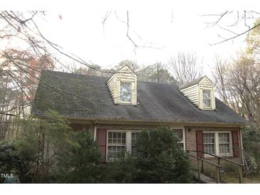 Charming brick home featuring upper dormer windows and traditional shutters at 105 Mary St, Carrboro, NC 27510