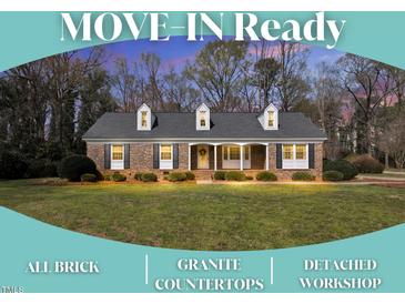 Charming, all-brick, one-story home featuring a well-manicured lawn and a welcoming front porch at 1192 Princeton Kenly Rd, Kenly, NC 27542