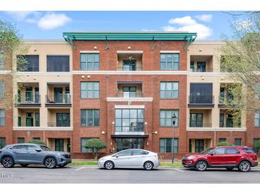Beautiful brick condo building with multiple levels and parking available in front on a clear day at 300 Finsbury # 115, Durham, NC 27703