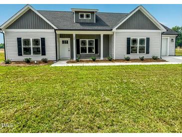 Charming single-story home with a well-manicured lawn, symmetrical design, and welcoming entrance at 400 S Eastwood Dr, Benson, NC 27504