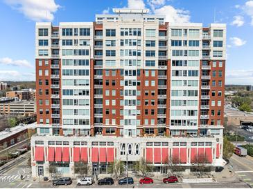 Spacious building with red awnings offers a modern urban living experience in a prime location at 400 W North St # 900, Raleigh, NC 27603