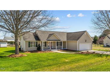 Charming single-story home features a well-manicured lawn, inviting porch, and attached two-car garage at 42 Galaxy Dr, Garner, NC 27529