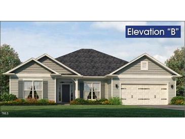 Charming single-story home with a neatly manicured lawn, attached two-car garage, and gray siding at 583 Sweet Potato Lane # 06, Nashville, NC 27856