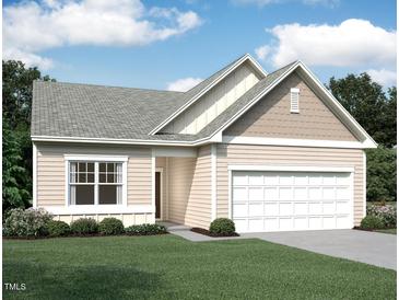 Charming single-story home showcasing a two-car garage, neutral siding, and a well-manicured lawn at 100 Big Dream Ct, Louisburg, NC 27549