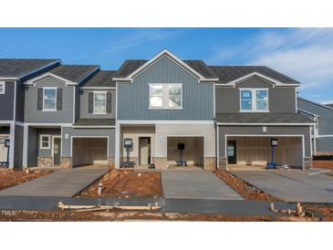 New townhouse construction showing the exterior with garage and driveway at 1171 Abbott St, Mebane, NC 27302