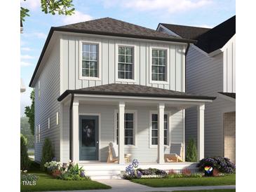 Charming two-story home with light siding, a welcoming front porch, and beautifully landscaped front yard at 123 Weavers Grove Dr, Chapel Hill, NC 27514