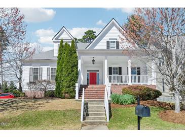 Charming two-story home with a bright red front door, white trim, and landscaped yard at 301 Kinsale Dr, Chapel Hill, NC 27517