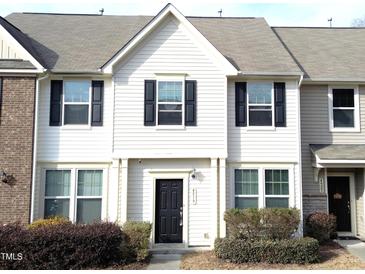 Charming townhouse with neutral siding, black door and shutters, and well-maintained landscaping at 4519 Tarkiln Pl, Wake Forest, NC 27587