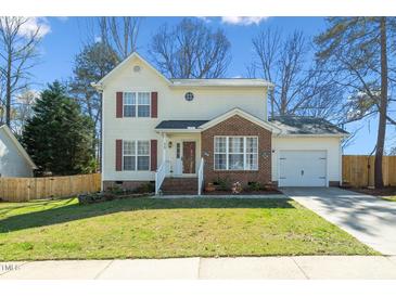 Charming two-story home with red shutters, brick accents, attached garage, and well-maintained lawn at 605 Wyndham Dr, Fuquay Varina, NC 27526