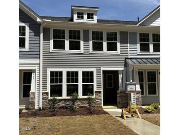 Charming townhouse with stone accents, neutral siding, and bright white-framed windows at 6409 Granite Quarry Dr, Raleigh, NC 27610