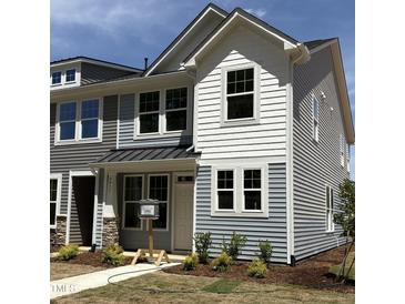 Charming two-story home with white siding, large windows, and a well-manicured lawn at 6411 Granite Quarry Dr, Raleigh, NC 27610