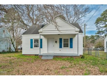 Charming white home with blue shutters and a cozy front porch is ready for move in at 824 S Tillery St, Rocky Mount, NC 27803
