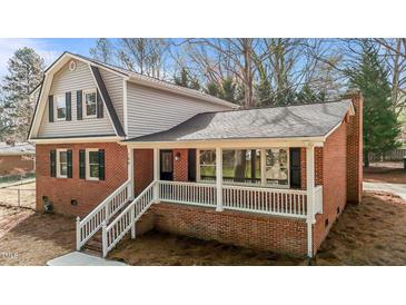 Charming brick two-story home with covered front porch and classic black shutters at 100 Royall Rd, Oxford, NC 27565