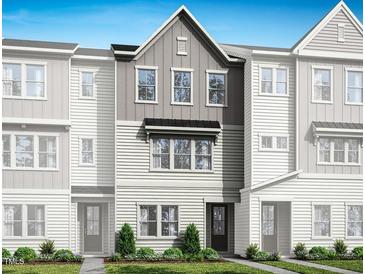 Charming townhome featuring a modern gray facade and inviting curb appeal at 1030 Zelkova Ln, Chapel Hill, NC 27517