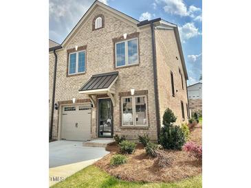 Charming brick home with manicured landscaping, an attached garage, and a welcoming front entrance at 1041 Beechcraft Dr # 119, Mebane, NC 27302